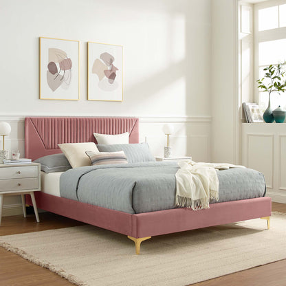 Pink upholstered bed with tufted headboard and gold legs, gray bedding, cream throw, white nightstands, framed abstract art.