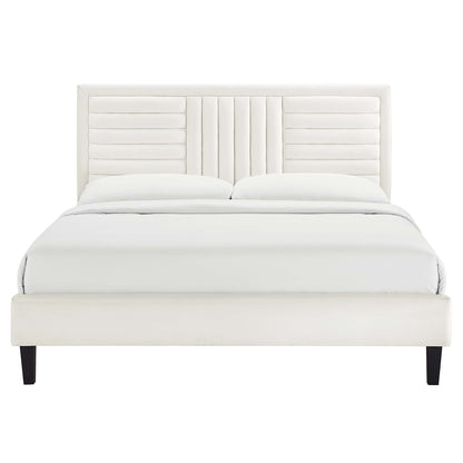 White velvet king platform bed with a channel-tufted headboard, dark wood legs, and white bedding.