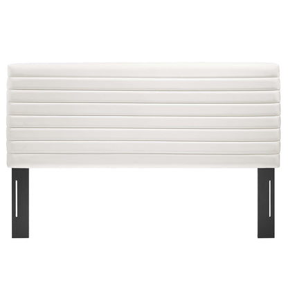 White upholstered headboard with horizontal channel tufting on black metal legs.