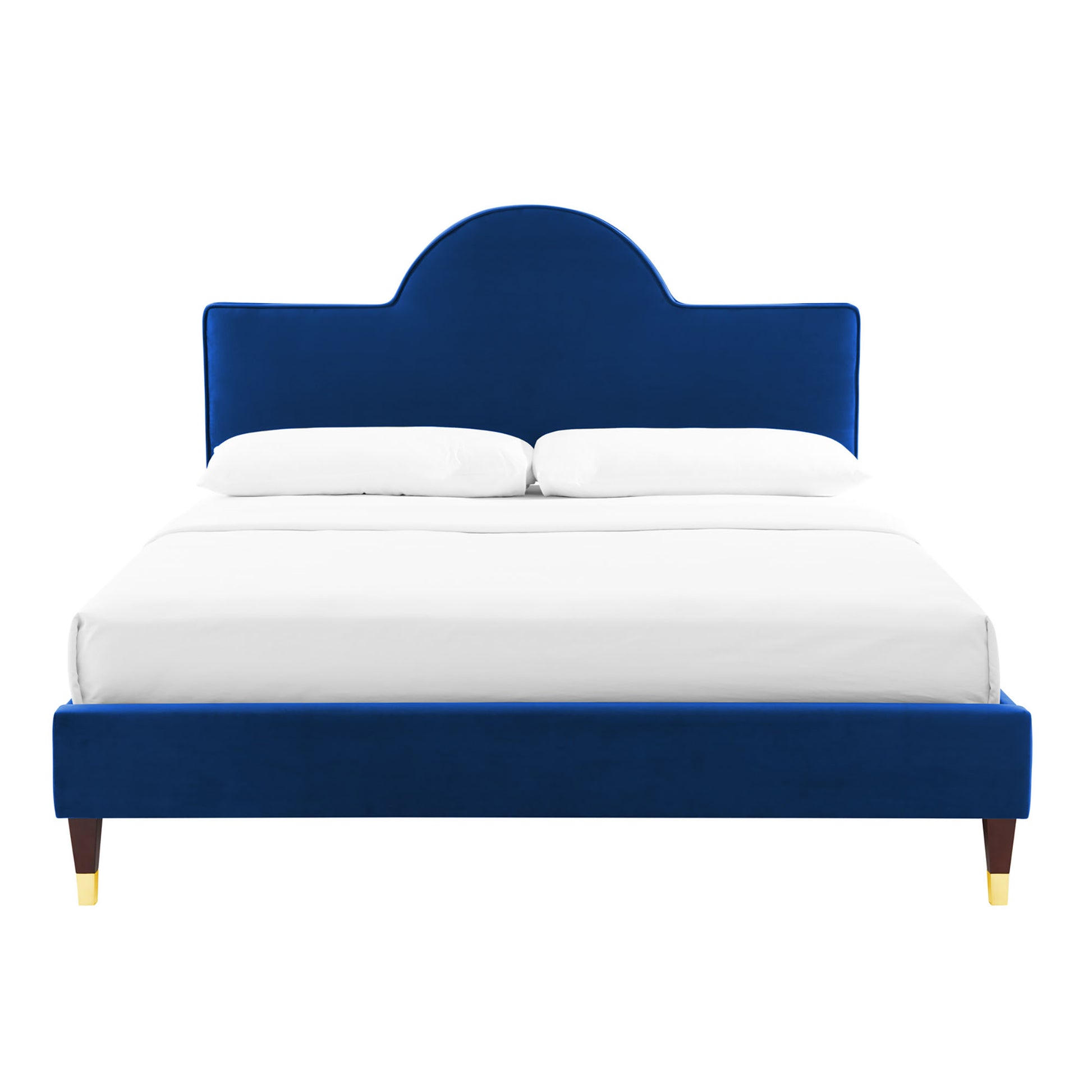 Navy blue velvet upholstered bed with a rounded arch headboard, white linens, and dark wood legs with gold tips.