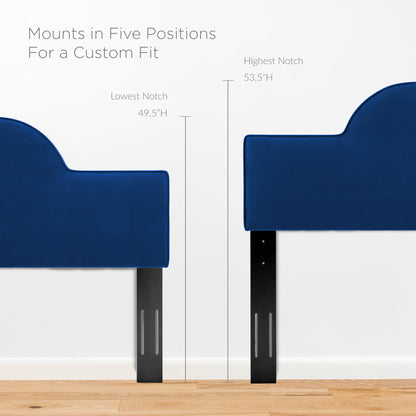Navy velvet full bed on black adjustable metal legs with curved tops, mounted on wood floor.