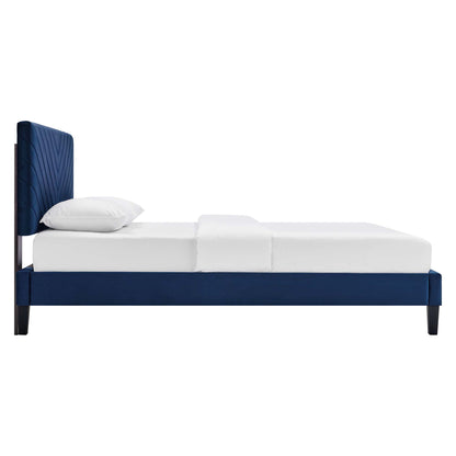Navy blue upholstered platform bed with tall quilted headboard and white bedding.