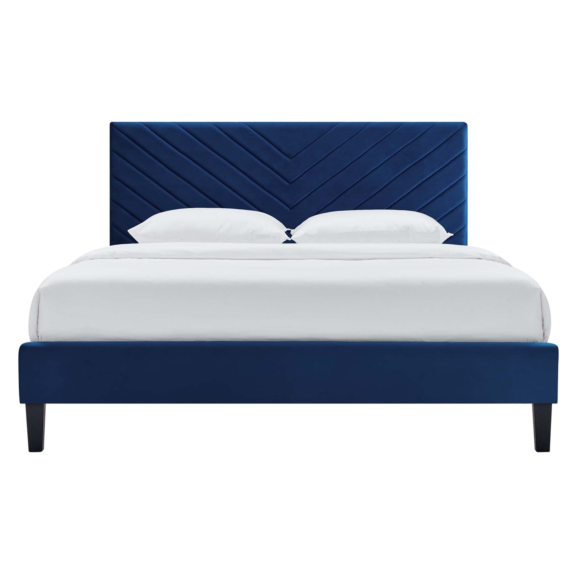 Navy blue velvet full platform bed with chevron-tufted headboard and low platform frame, white bedding, modern style.