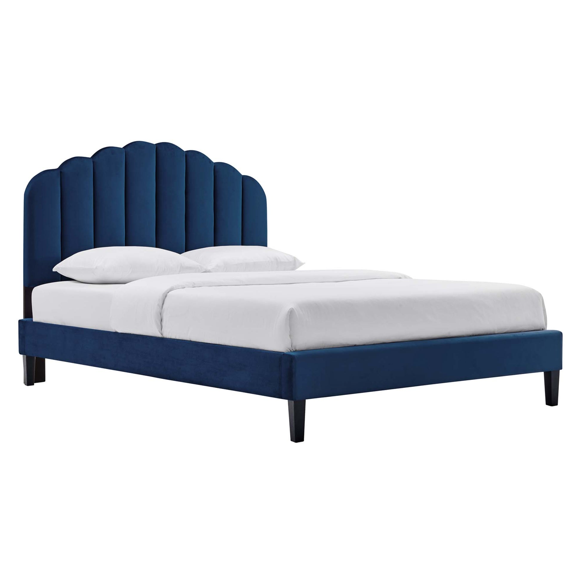 Navy blue velvet upholstered platform bed with curved vertical tufted headboard and white bedding.