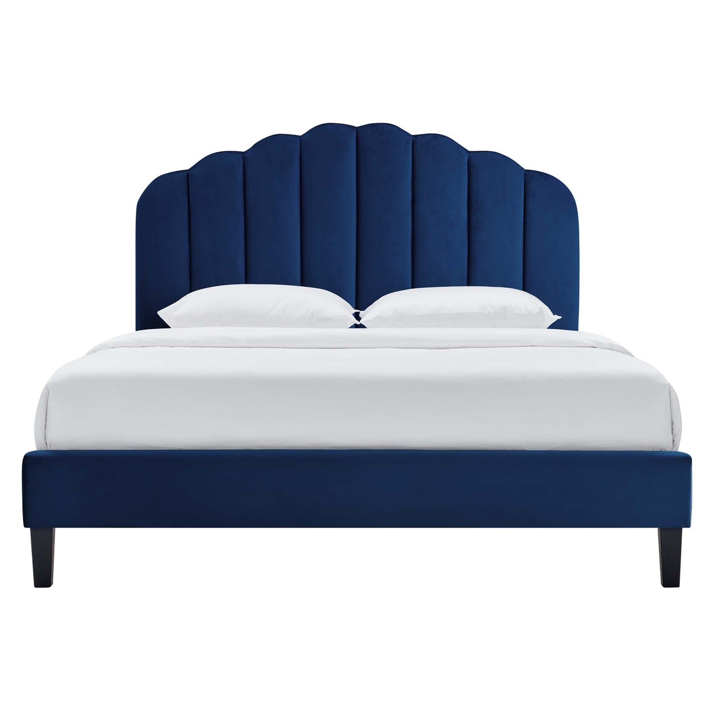 Navy blue velvet upholstered full platform bed with scalloped arch headboard and white bedding.