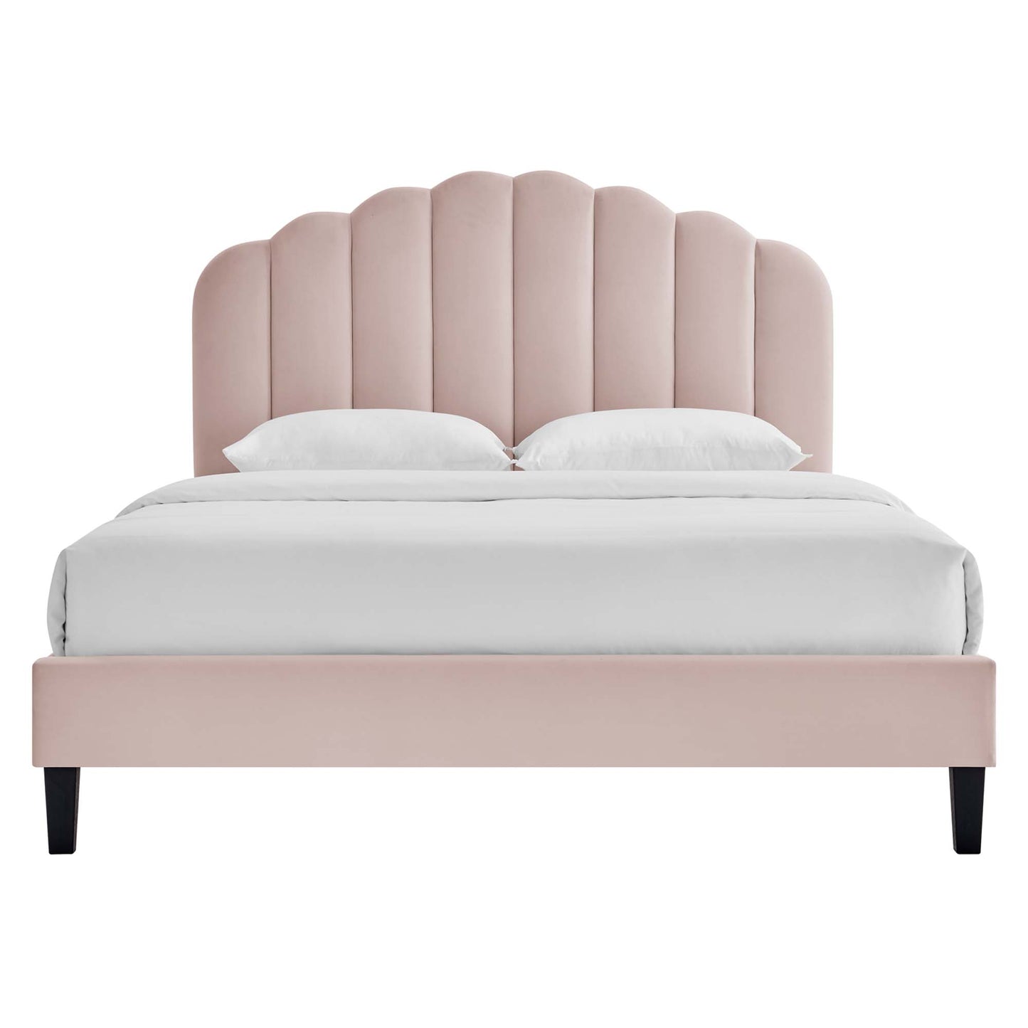 Blush pink upholstered full platform bed with scalloped headboard, white bedding, and black legs.
