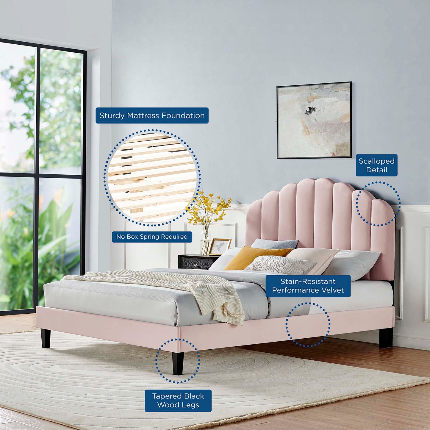 Soft pink velvet platform bed with curved tufted headboard and tapered black wood legs in a modern bedroom.