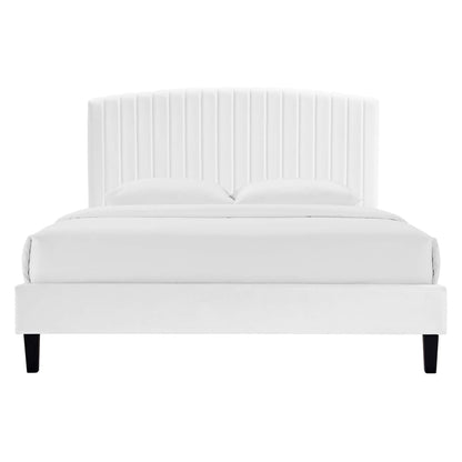 White upholstered bed with tall vertical channel-tufted headboard and black tapered legs.