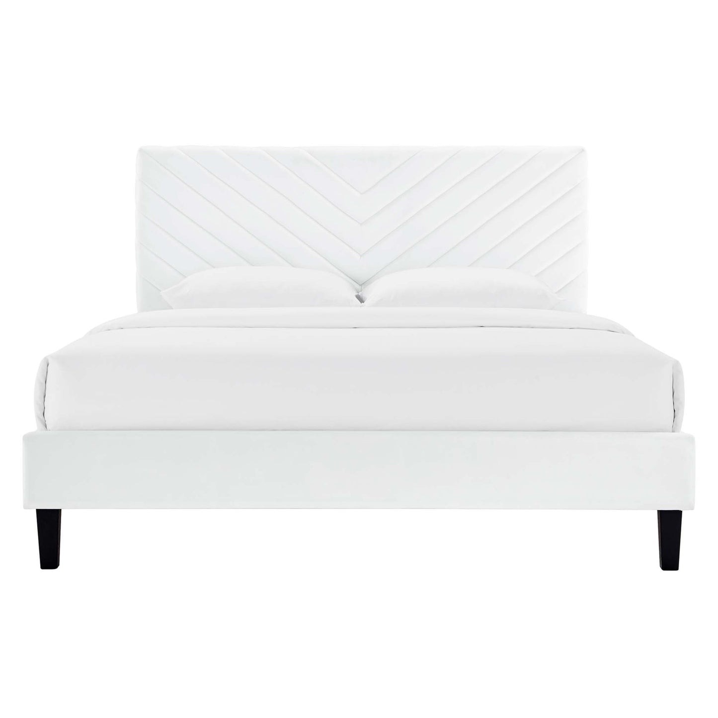 White upholstered bed with chevron headboard, platform base, two pillows and black legs.
