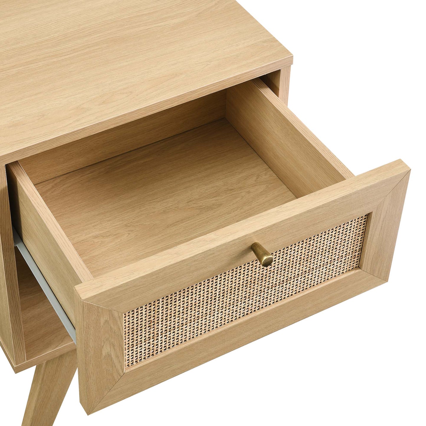 Brown oak mid-century nightstand with angled legs; open front drawer with woven cane panel and brass knob.