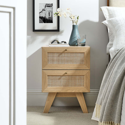 Oak two-drawer nightstand with woven cane fronts and tapered legs; mid-century style.