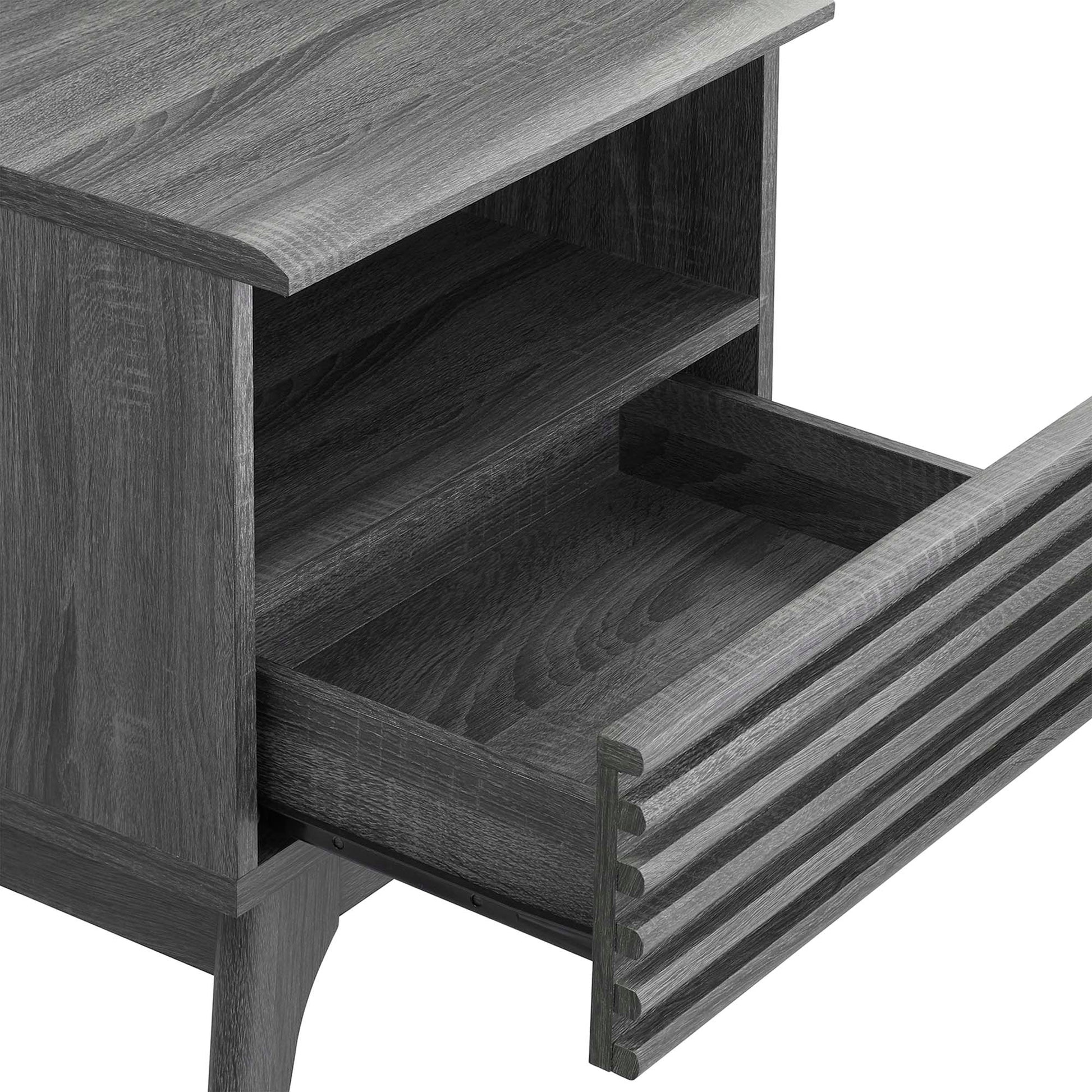 Black wood nightstand with open shelf and grooved-front drawer; tapered legs.