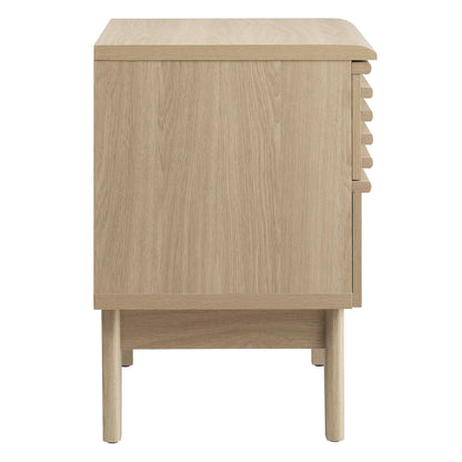 Oak wood nightstand on tapered legs with curved top edge.