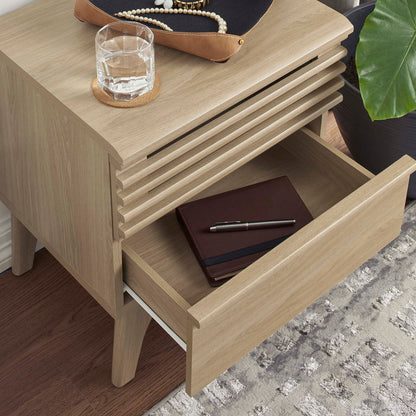 Oak nightstand with slatted drawer front; open drawer holds notebook and pen; top jewelry tray with pearls, glass on coaster.