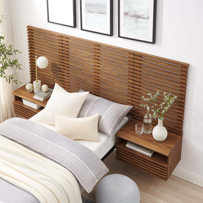 Walnut slatted headboard with built-in nightstands, bed with gray/cream bedding, vase with branches, lamp, and plant decor.
