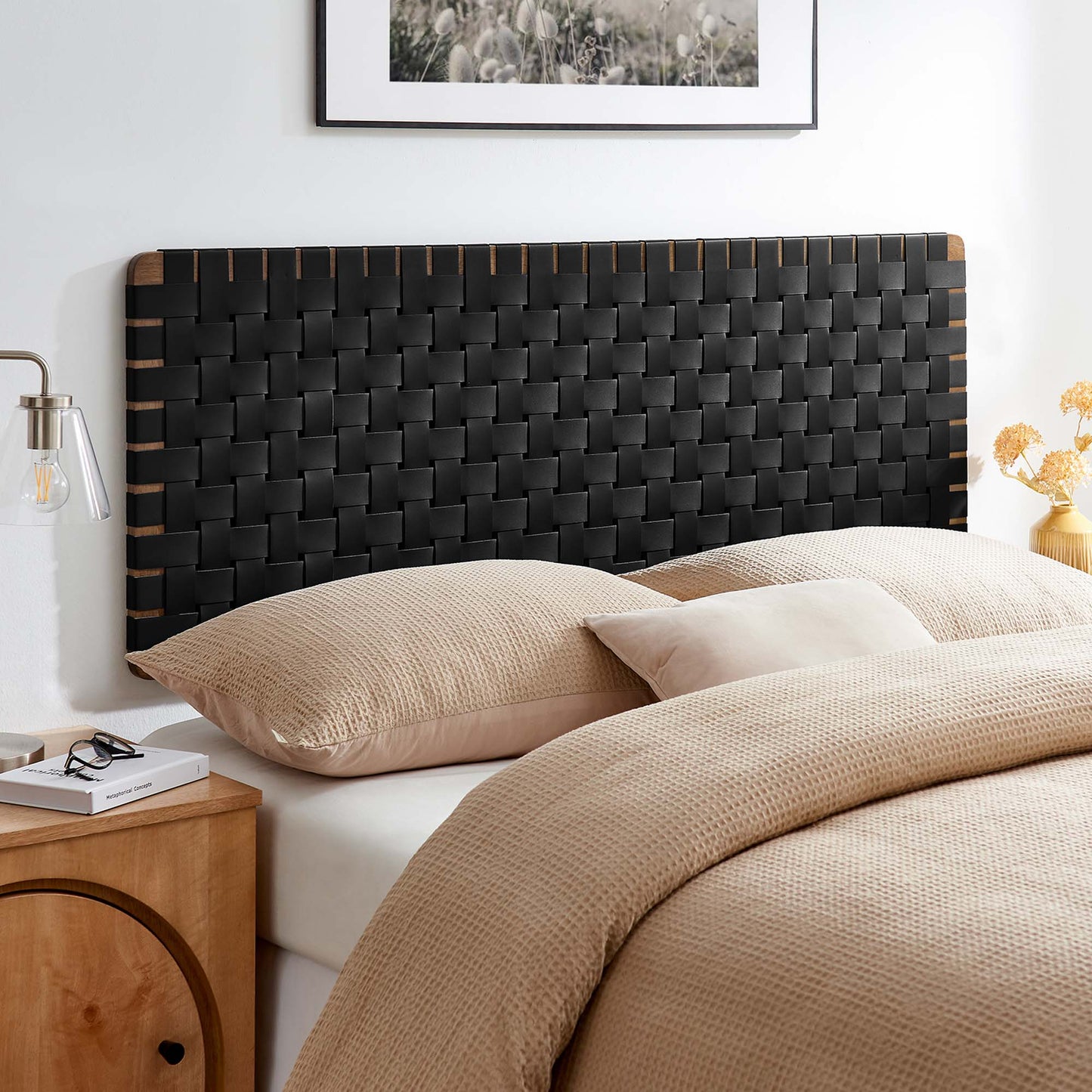 Woven black headboard with walnut edge accents, beige duvet and matching pillows in a modern bedroom.