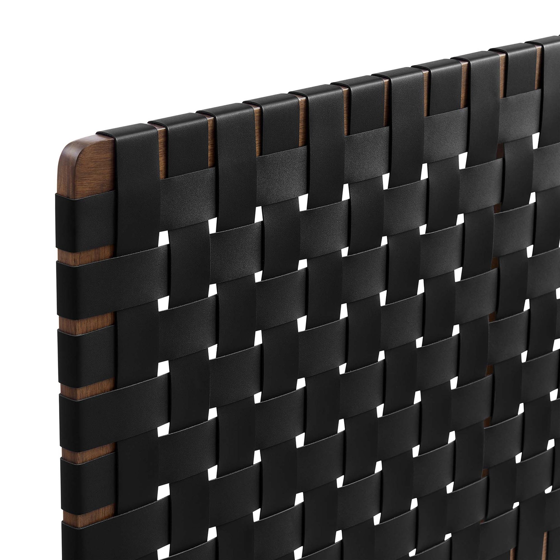 Close-up of a walnut wood-framed headboard with a black vegan leather weave in a grid pattern.