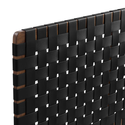 Close-up of a walnut wood-framed headboard with a black vegan leather weave in a grid pattern.