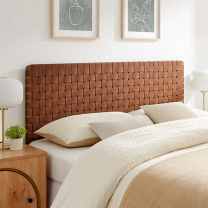 Walnut brown woven leather headboard on a beige bed with cream linens; wooden nightstand and white lamp.