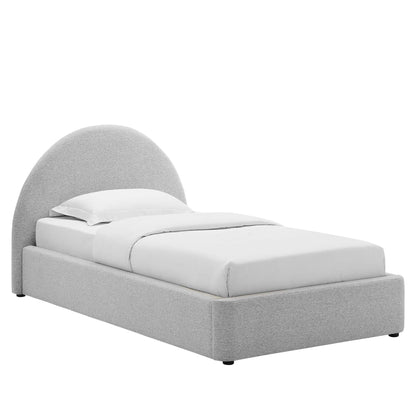 Light gray upholstered platform bed with a rounded arch headboard and white bedding.