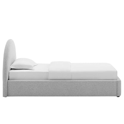 Light gray upholstered platform bed with a tall curved headboard and white linens.