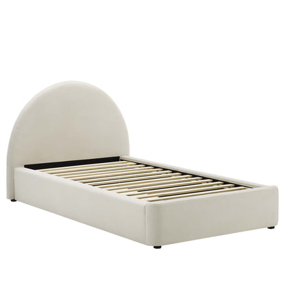 White upholstered twin platform bed with an arched rounded headboard and a slatted base.