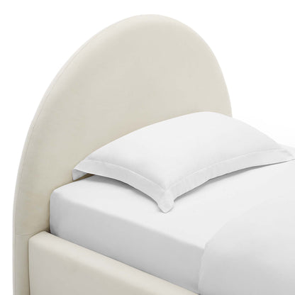 Cream curved upholstered headboard bed with white sheets and pillow