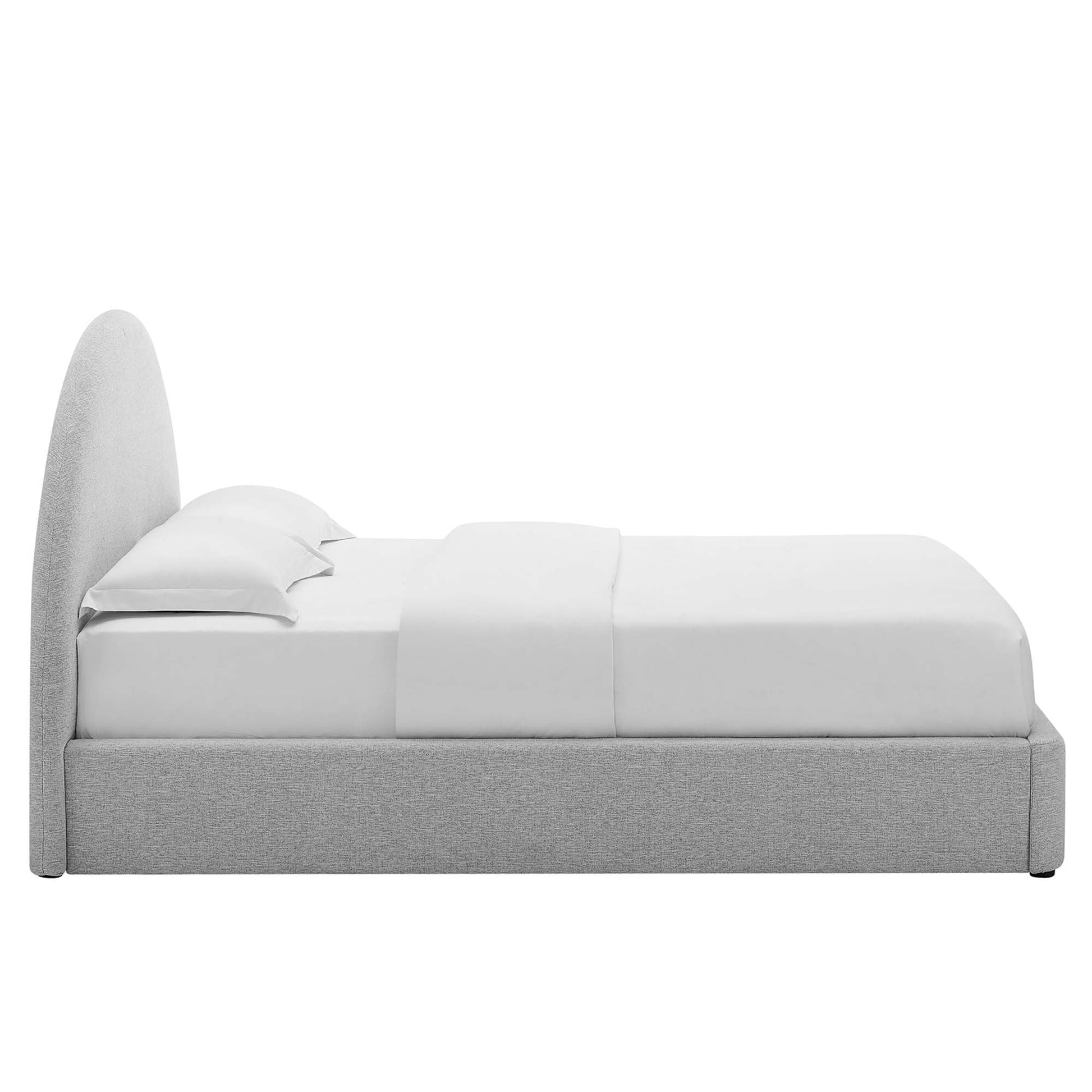 Grey upholstered platform bed with a tall curved headboard and white sheets and pillows.