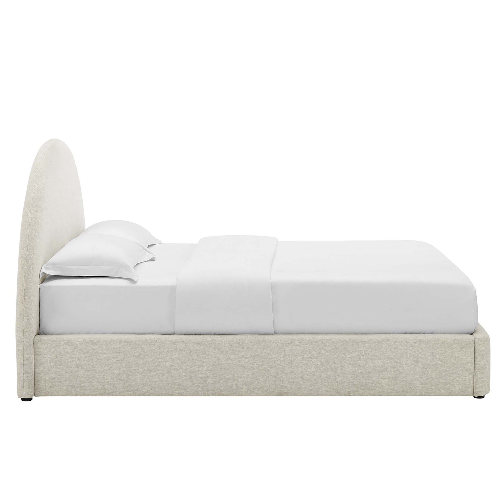 White upholstered queen platform bed with an arched round headboard & white sheets & pillows.
