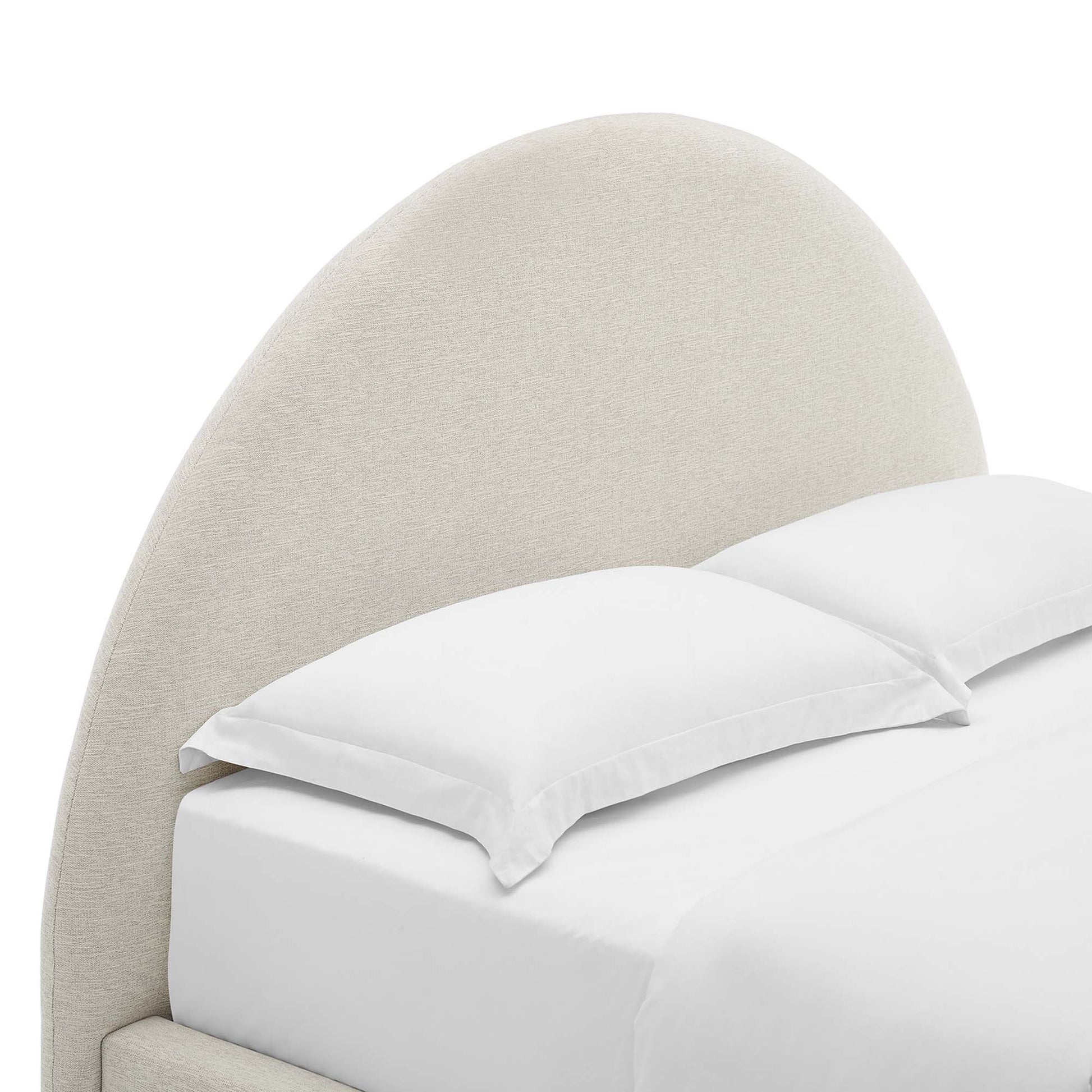 Light beige curved upholstered headboard with white bedding & pillows, modern bed.