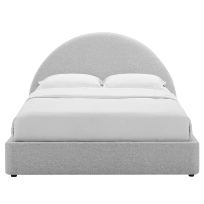 Light grey fabric upholstered platform bed with a tall curved arch headboard and white bedding.