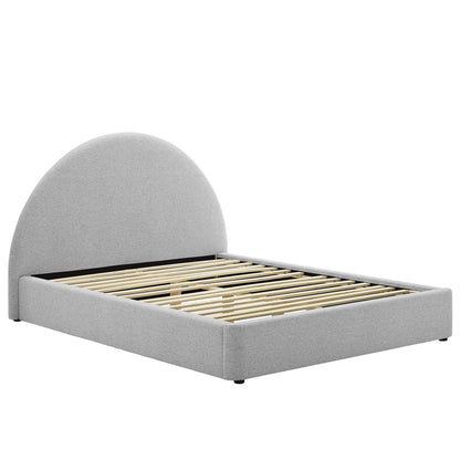Light gray upholstered platform bed with rounded arch headboard and wooden slat base.
