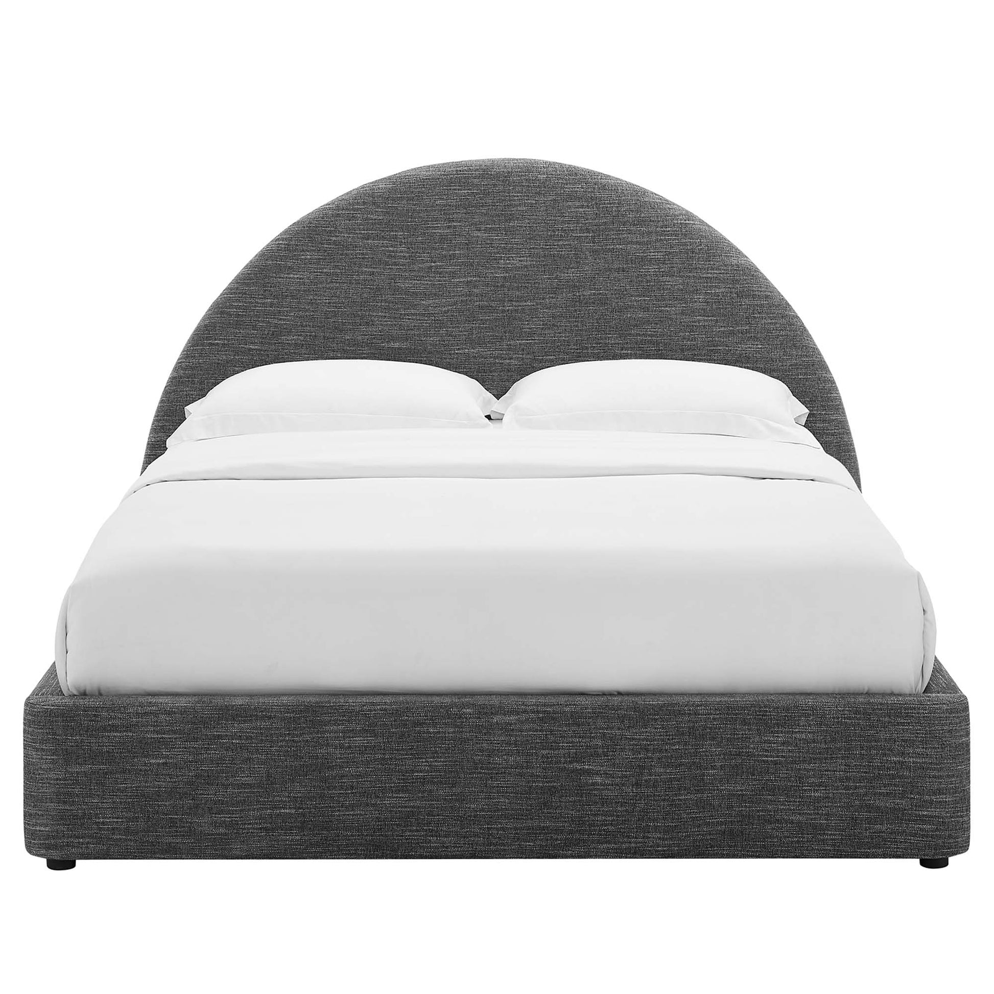 Dark gray fabric upholstered platform bed with a curved semicircular headboard & white bedding.