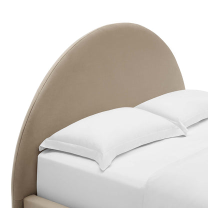 Taupe curved upholstered headboard with white bedding and pillows on a bed.