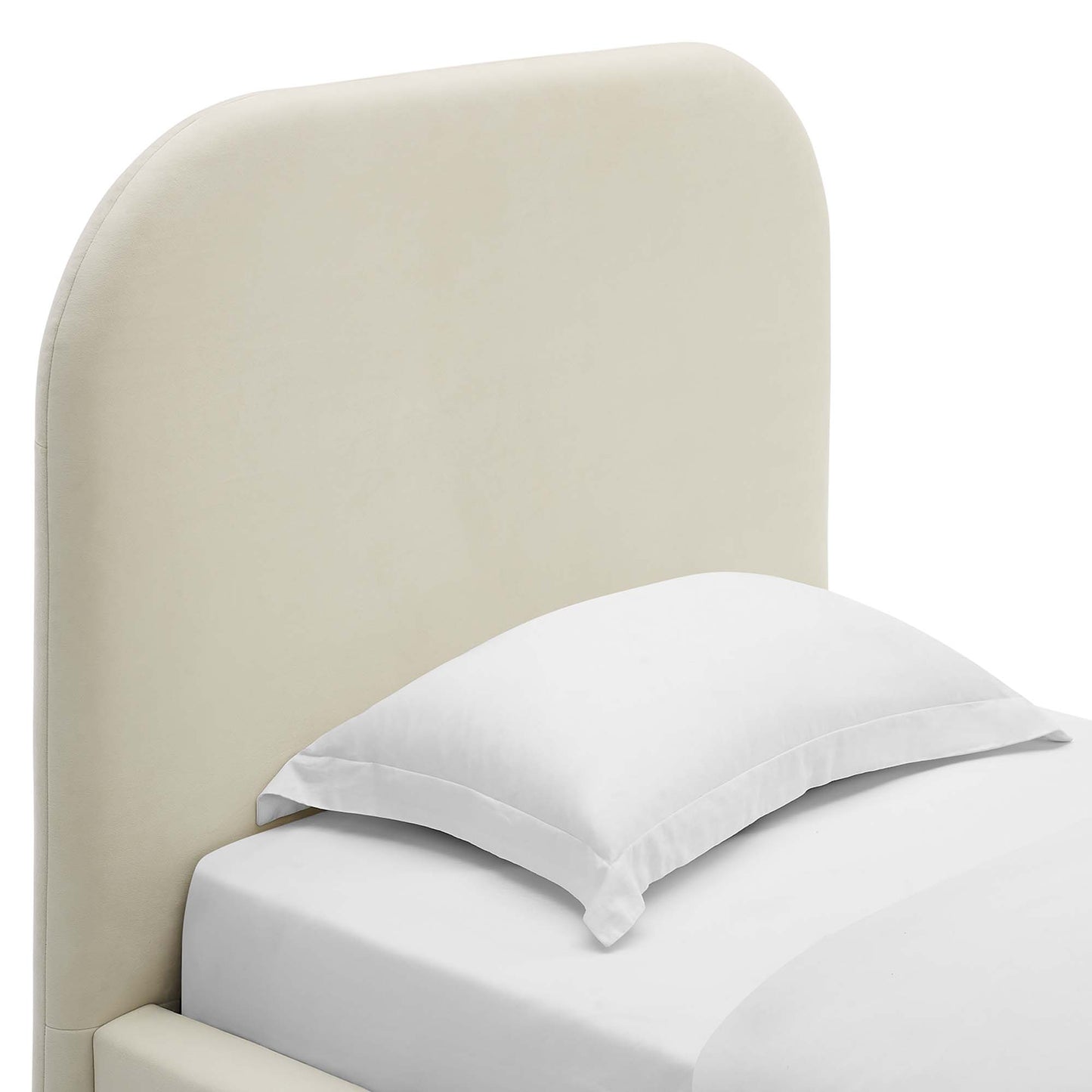 White twin platform bed with a curved upholstered headboard and white bedding in a modern minimalist bedroom setup.