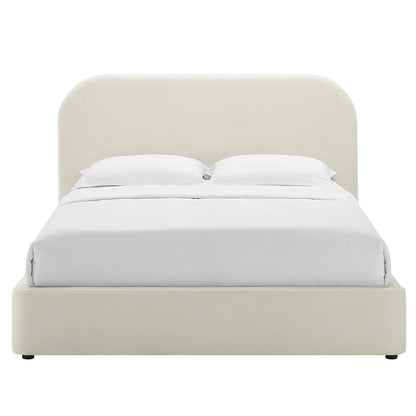Cream fabric upholstered platform bed with a rounded arch headboard and white sheets.