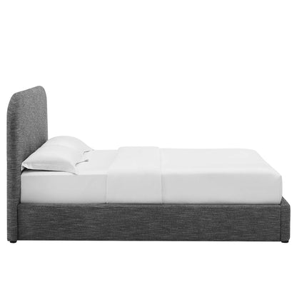 Dark grey fabric platform bed with tall curved headboard and white bedding.