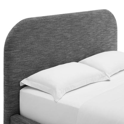 Grey textured curved upholstered headboard on a king platform bed with two white pillows and white bedding.