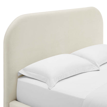White upholstered curved headboard with white bed sheets and two white pillows.