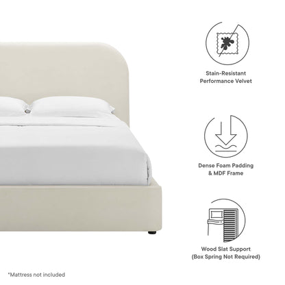 Cream velvet upholstered platform bed with rounded headboard, white bedding; foam padding, MDF frame, wood slat support.