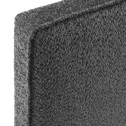 Charcoal gray boucle fabric close-up on a twin headboard; textured surface and edge.