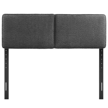 Two-panel dark gray boucle fabric padded headboard on black adjustable metal legs
