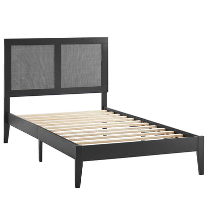 Black platform bed frame with a low-profile headboard featuring two rattan panels & wooden slat support.