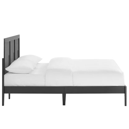 Black rattan and wood full platform bed with vertical slat headboard, white bedding, modern minimalist style.
