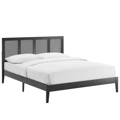 Black platform bed with paneled headboard, low-profile frame, four tapered legs and white bedding