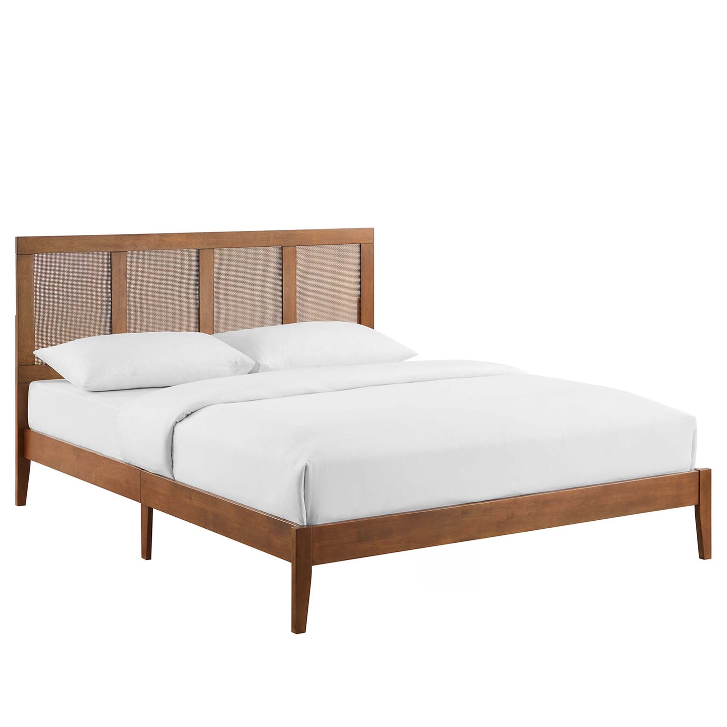 Walnut-finish king platform bed with paneled headboard and woven cane inserts, white bedding, four tapered legs.