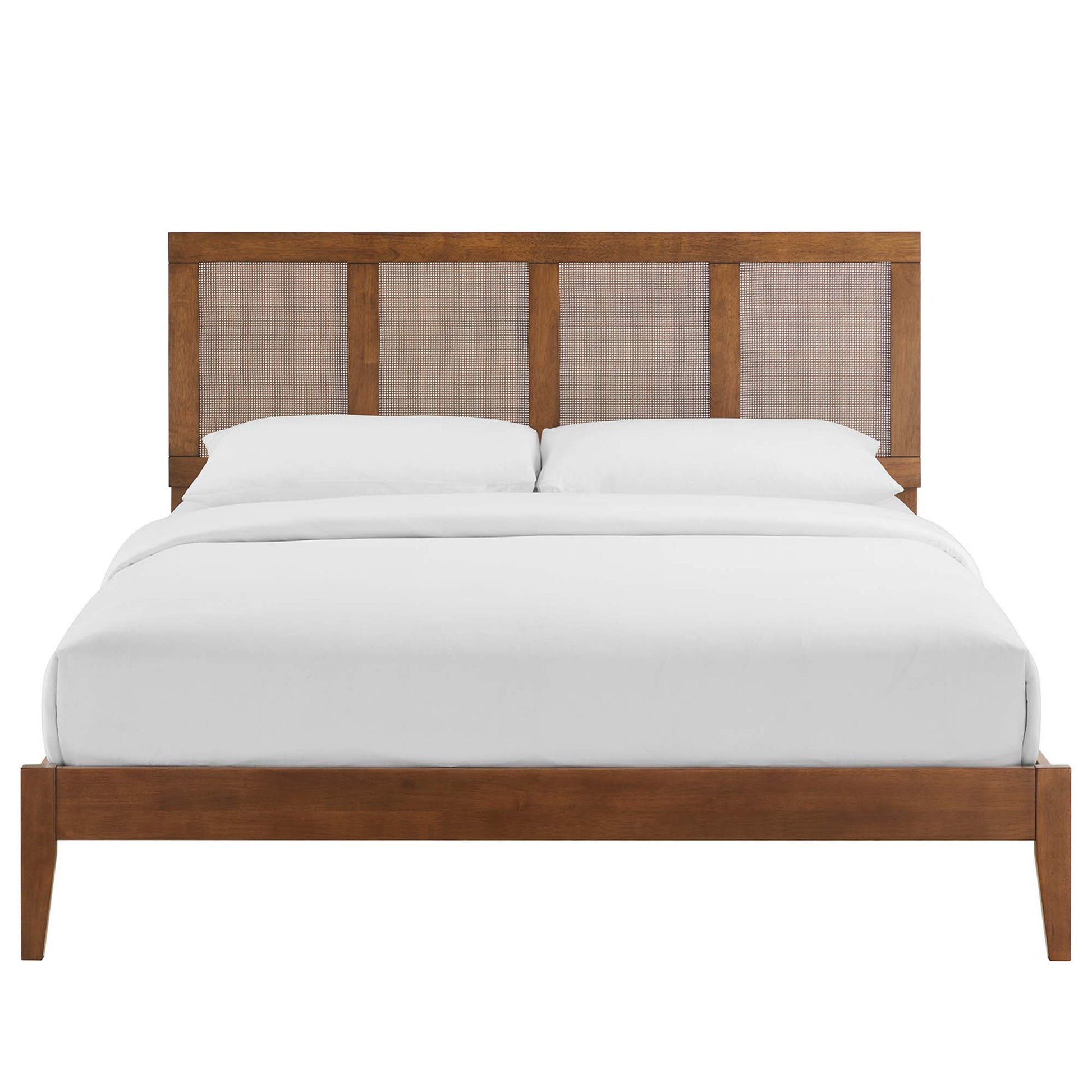Walnut wood bed with a four-panel beige upholstered headboard and white bedding; clean mid-century modern design.