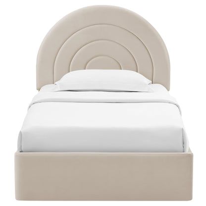 Beige upholstered platform bed with rounded concentric arch headboard and white bedding; modern bedroom centerpiece.