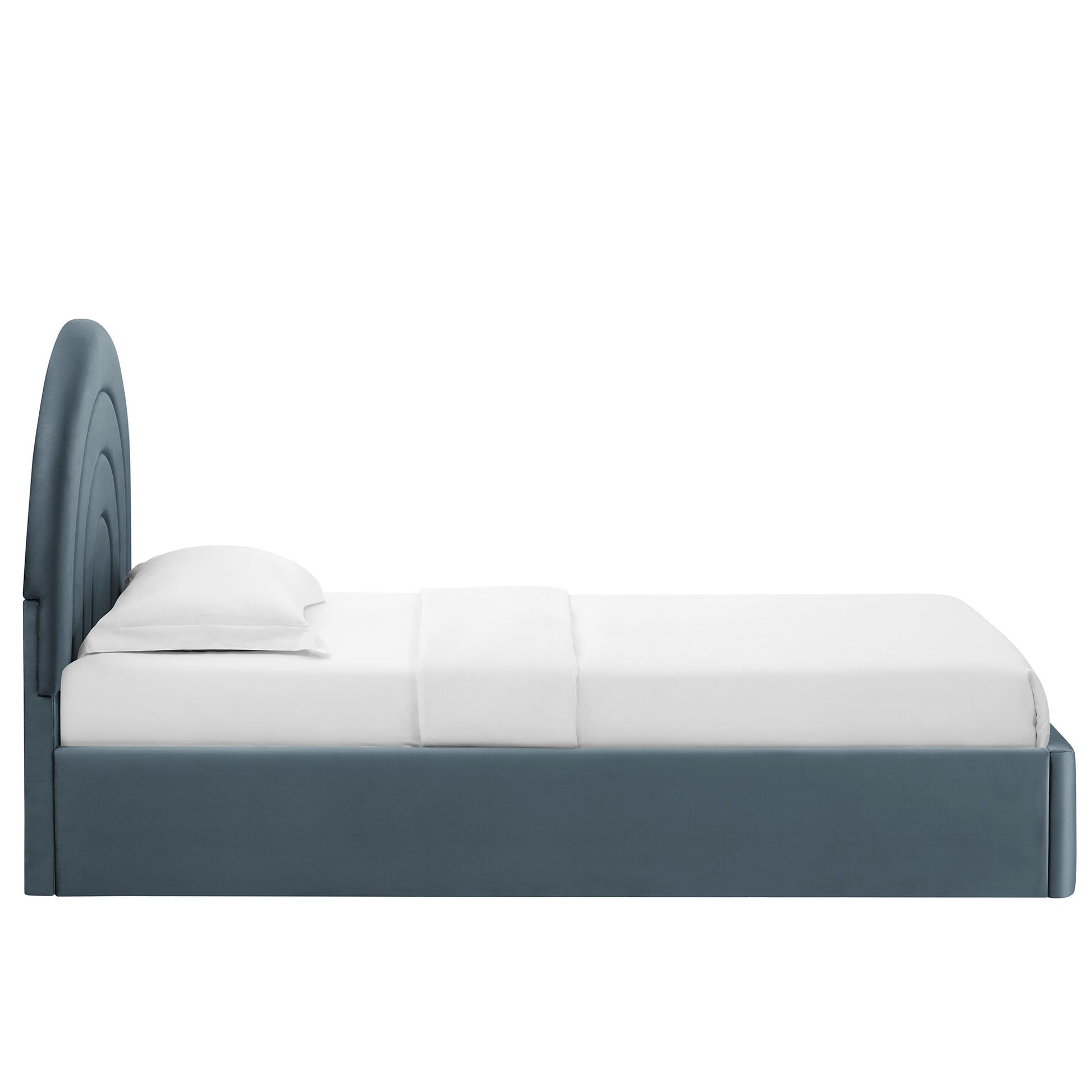 Blue-gray upholstered platform bed with a rounded arched headboard and white bedding, modern coastal style.
