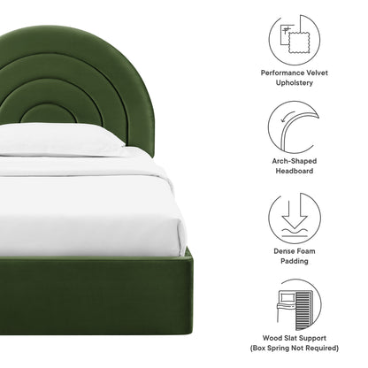 Green velvet bed with an arch-shaped headboard, white bedding, foam padding, and wood slat support